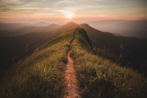 The way of climax. Mountain slope have a way for walk. Background is sunset.